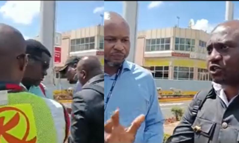Passengers engaging KQ officials at the JKIA.